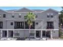 Elegant three-story townhome with well-maintained landscaping and private balconies for outdoor enjoyment at 12955 Cats Claw Ln, Orlando, FL 32828