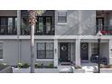Elegant townhome exteriors with private balconies, complemented by manicured landscaping and inviting entrances at 12955 Cats Claw Ln, Orlando, FL 32828
