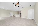 The open-concept area showcases a ceiling fan and neutral wall paint at 1415 Oak Marsh St, Davenport, FL 33837