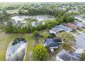 Aerial view of the home with ponds and lush green surroundings in a peaceful neighborhood setting at 14620 Old Forest Ct, Orlando, FL 32826