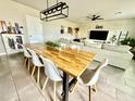 Contemporary dining area with a large wooden table, modern chairs, and an open-concept design at 1513 Congaree St # 1513, Davenport, FL 33837