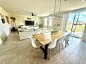 Open-concept living space featuring a dining area, a modern sofa, and a sliding glass door at 1513 Congaree St # 1513, Davenport, FL 33837