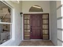 Inviting entryway showcasing a front door with sidelights, transom window, and modern lighting fixtures at 2218 Newt St, Orlando, FL 32837