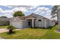 Charming home with a well-manicured lawn, beautiful landscaping, and a two-car garage at 2218 Newt St, Orlando, FL 32837