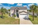 Inviting home featuring a lush lawn and a spacious two-car garage at 2315 Anhinga Dr, Kissimmee, FL 34743