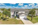 Beautiful two-story home with an attached two car garage surrounded by lush landscaping at 2315 Anhinga Dr, Kissimmee, FL 34743