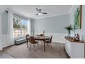 Cozy dining area with modern lighting, neutral walls, and large windows offering a pleasant view at 248 Wallrock Ct, Ocoee, FL 34761