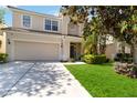 Charming two-story home features a well-maintained lawn and an attached two-car garage at 2509 Archfeld Blvd, Kissimmee, FL 34746