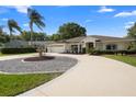 This home includes mature trees and landscaping, a circular drive, and a two car garage at 26901 Racquet Cir, Leesburg, FL 34748