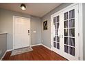 Inviting entryway boasts hardwood floors, white trim, and charming French doors at 297 Sky Valley St, Clermont, FL 34711