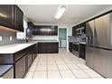 Spacious kitchen with stainless steel appliances, ample counter space, and dark wood cabinets at 297 Sky Valley St, Clermont, FL 34711