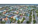Aerial view of a colorful community with well-maintained homes and landscaping at 3083 Key Lime Loop, Kissimmee, FL 34747