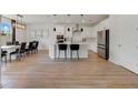 The kitchen features a spacious island with seating, stainless steel appliances, and modern lighting at 5660 Oak Knoll Dr, St Cloud, FL 34771