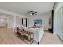 The bright living room features stylish wood floors, an open floorplan, and lots of natural light at 5660 Oak Knoll Dr, St Cloud, FL 34771