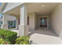 Covered front porch with support columns and a stylish front door, creating a welcoming entrance at 5829 Valentino Way, Lakeland, FL 33812