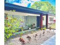 This home features a well-manicured yard with decorative rock, flowerbeds, and healthy landscaping at 605 Ensenada Dr, Orlando, FL 32825