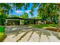 Lovely single-story home with a well-kept lawn, mature trees, and attached garage at 605 Ensenada Dr, Orlando, FL 32825