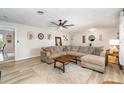 Spacious living room with a large sectional sofa, wood-look floors, and stylish decor at 605 Ensenada Dr, Orlando, FL 32825