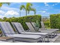 Relaxing lounge chairs near the pool area provide comfortable space in a serene setting at 7759 Westland Dr, Kissimmee, FL 34747