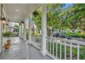 Spacious porch view showing white railing, stately columns and a glimpse of a tree-lined street at 821 Veranda Pl, Celebration, FL 34747