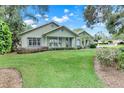 Charming home with rocking chairs on the front porch and well-maintained lawn and landscaping at 89 Pine Forest Ln, Haines City, FL 33844