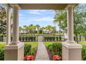 Inviting view from the column-lined porch, showcasing the well-maintained landscape and community at 9433 Randal Park Blvd, Orlando, FL 32832