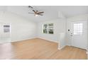Bright living room with light wood floors, a ceiling fan, and a front door at 25929 Newcombe Cir, Leesburg, FL 34748