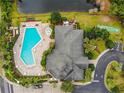 Stunning aerial view of community pool, clubhouse, and surrounding landscaping at 9051 Treasure Trove Ln # 405, Kissimmee, FL 34747