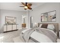 Spacious main bedroom with ceiling fan, artwork, and entry to an attached bathroom at 503 Moree Loop, Winter Springs, FL 32708
