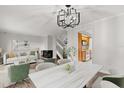 Bright open-concept living room featuring a fireplace, staircase, and modern light fixture at 503 Moree Loop, Winter Springs, FL 32708