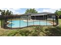 Spacious kidney-shaped pool with fence and covered patio area at 7584 Lodge Pole Trl, Winter Park, FL 32792