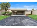 Open carport with asphalt driveway, room for 2 cars and a cozy garden at 106 Madrid Dr, Casselberry, FL 32707