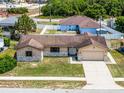 Charming single-story home with a well-maintained lawn, stone accents, and a two-car garage at 1132 Feather Dr, Deltona, FL 32725