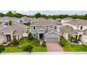 Aerial view of a neighborhood featuring a two-story home with manicured lawn at 1317 Yorkdale Rd, Davenport, FL 33837