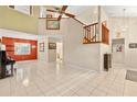 Bright living room with tile flooring, high ceilings, and staircase leading to the second floor at 1532 Lawndale Cir, Winter Park, FL 32792