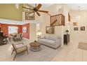 Spacious living room with high ceilings, fan, tile floors, and open to the dining area at 1532 Lawndale Cir, Winter Park, FL 32792