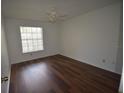 Cozy bedroom with laminate flooring, a ceiling fan, and a bright window at 1075 S Hiawassee Rd # 916, Orlando, FL 32835