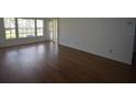 Bright living room with laminate flooring and ample natural light from large windows at 1075 S Hiawassee Rd # 916, Orlando, FL 32835