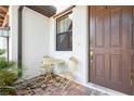 Cozy front porch with a table and chair set, perfect for relaxing outdoors at 1350 Royal St George Blvd, Davenport, FL 33896