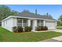 Well-maintained single Gathering home with mature landscaping, a garage and a paved driveway at 1440 Lake Shore Dr, Casselberry, FL 32707