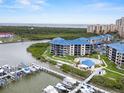 Aerial view of condos with boat docks and community pool, emphasizing waterfront living and amenities at 2700 N Peninsula Ave # 314, New Smyrna Beach, FL 32169