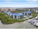 Scenic aerial view of condo complex with pool, pier and water access, showcasing the coastal lifestyle at 2700 N Peninsula Ave # 314, New Smyrna Beach, FL 32169