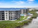 Exterior shot of condo building with pool and bay access, highlighting the beautiful waterfront location at 2700 N Peninsula Ave # 314, New Smyrna Beach, FL 32169