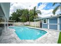 Inviting backyard pool featuring ample patio space, landscaping, and a storage shed at 2707 Prince John Rd, Winter Park, FL 32792