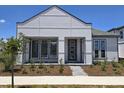 Modern home featuring a front entrance and professionally landscaped yard at 2976 Embark Trail, St Cloud, FL 34771