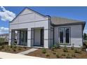A modern exterior view of a single-Gathering home featuring a symmetrical design with gray accents at 2976 Embark Trail, St Cloud, FL 34771