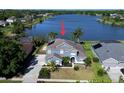 Aerial view of the beautiful home with a picturesque lake in the backyard at 318 Osprey Lakes Cir, Chuluota, FL 32766