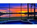 Enjoy breathtaking sunset views over the lake from the screened-in pool and spa area at 318 Osprey Lakes Cir, Chuluota, FL 32766