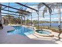 Enjoy the large screened-in pool and spa with views of the lake at 318 Osprey Lakes Cir, Chuluota, FL 32766