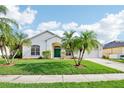Beautiful single-Gathering home with lush green lawn and well-maintained landscaping at 3514 Forest Ridge Ln, Kissimmee, FL 34741